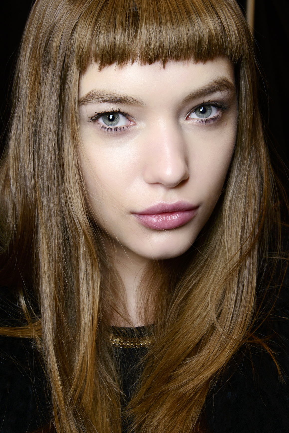 Blunt Short Bangs with Black Top and Gold Necklace