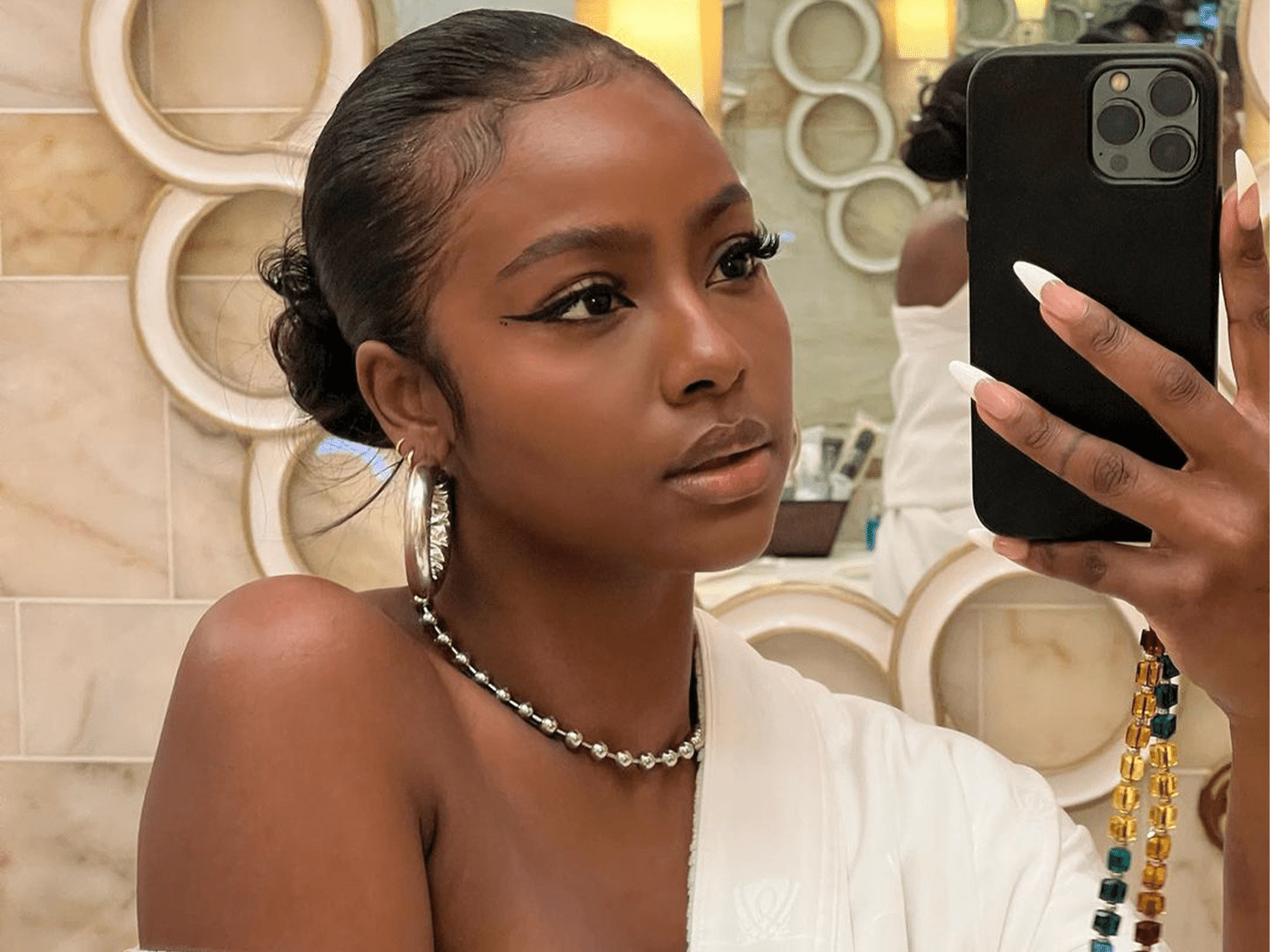 Slicked Black Bun With Wispy Baby Hairs — Slick Back Hairstyles